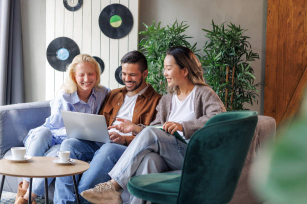 istock Brainstorming - Smiling coworkers using a laptop 2135870437