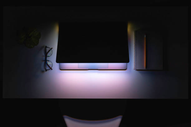 istock Laptop in the dark at night on the desktop. 2135876304