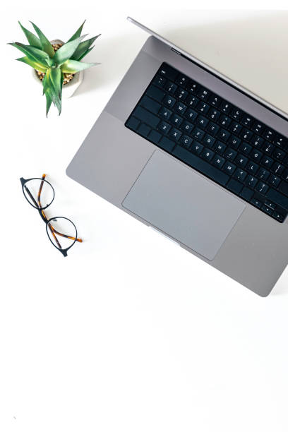 istock Laptop, glasses and flowerpot isolated on a white background. 2135876314