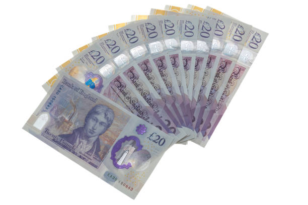 istock Wad of UK twenty pound notes - white background 2135900557