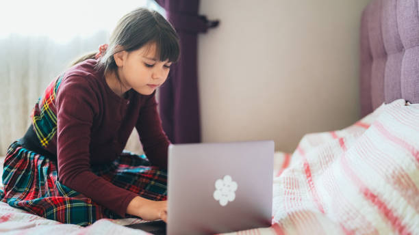 istock Schoolgirl online studying at home 2135909978