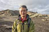 Profile View of a Retired Asian Hiker at Muriwai Beach