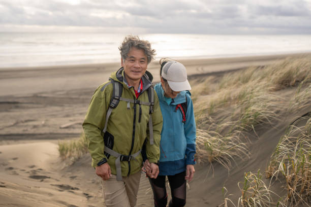 Asian Couple Hiking Along the Coast