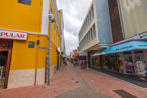 Willemstad. Curacao. 04.19.2024. Gorgeous view of the pedestrian street in the center of Willemstad with various shops on both sides.