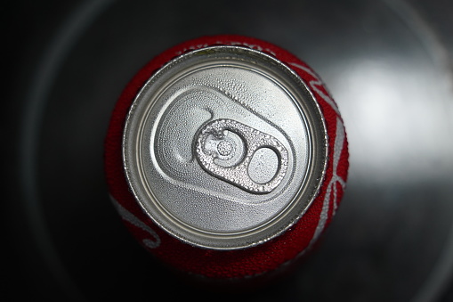 Soda can with water drops. Sugary and carbonated drink