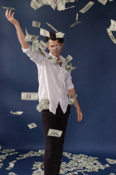 istock A guy in a suit and shirt throws dollars, dollars rain 2135937468