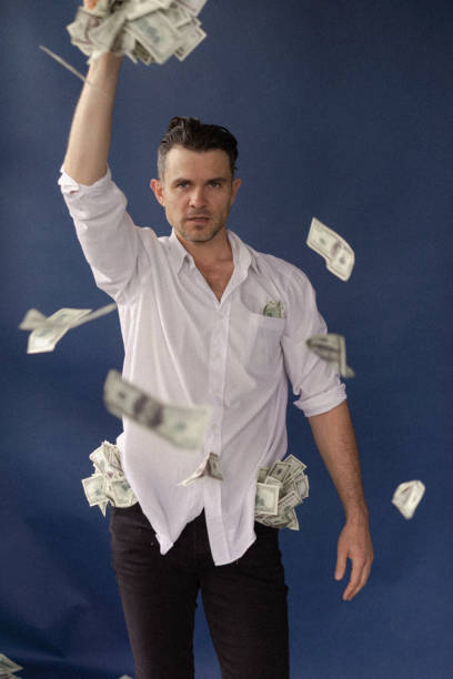 istock A guy in a suit and shirt throws dollars, dollars rain 2135937569