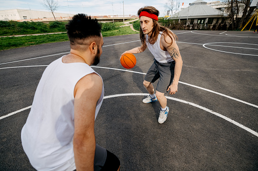 Two street basketball players having training outdoor.