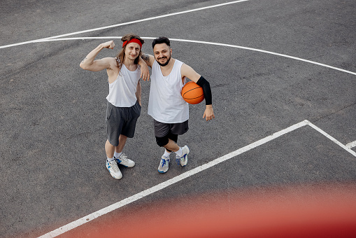 Two street basketball players having training outdoor.