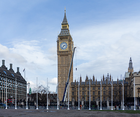 Renovated Big Ben in London in Spring 2023 with a crane in front of the monument