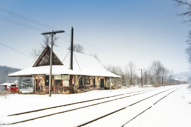 istock Abandoned train station in winter with snow covered railroad tracks 2135961524