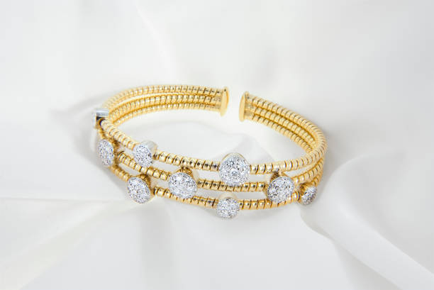 Gold Diamond Bracelet on Elegant White Satin stock photo