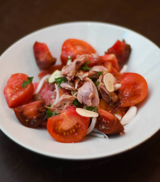 istock Tomato and tuna salad, with onion. 2135995087