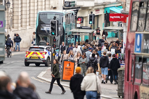 West Street & North Street Junction in Brighton BN1, Brighton And Hove, East Sussex, Southeastern England, United Kingdom, Britain, Europe - 16th March 2024: City Life, Cityscape - Amidst the traffic on West Street, and an urban, street view of Brighton and Hove City, a coastal city in East Sussex, England, UK, people strolled along the street while also cars and local double-decker buses navigated the lively flow, capturing the essence of this urban scene on West Street in Great Britain in Europe.