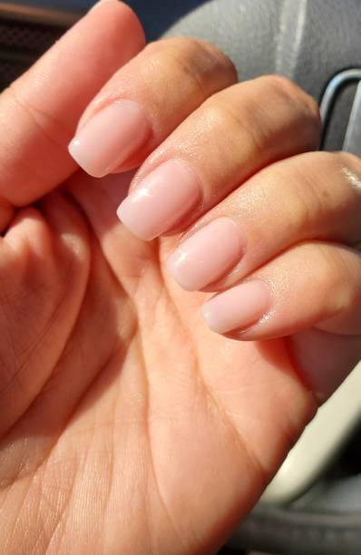 istock Left hand pink nude manicure 2136011412