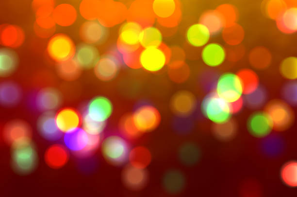 Orange defocused bokeh lights blur sparkling colorful background Gold lights Golden sparks glowing soft focus Luxury template New Year party Xmas Blurred texture Abstract motion template Christmas