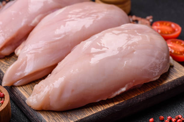 istock Fresh chicken fillet on a dark concrete table with spices and herbs 2136039495