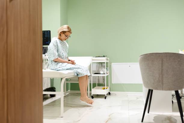 istock Side view of a woman sitting on exam table. 2136046703