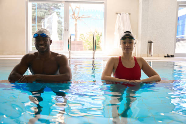 istock Swimmers posing for camera in sports pool 2136064648