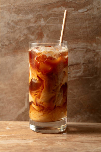 istock Iced coffee with cream on a beige ceramic table. 2136074460