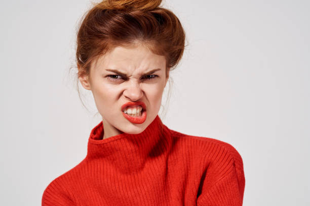 istock energetic woman in red sweater emotions fun irritability model 2136090891