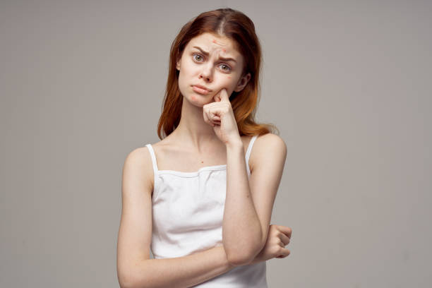 istock red-haired woman emotions model white t-shirt health problems 2136092496