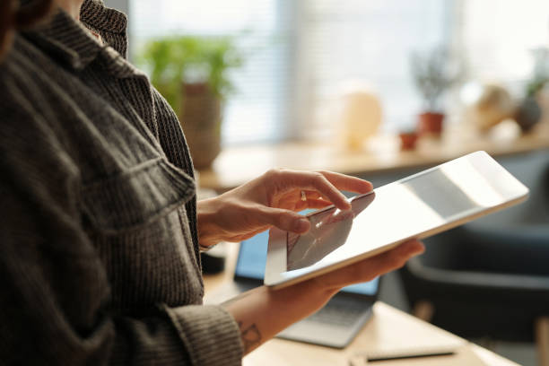 istock Hands of businesswoman using tablet 2136101949
