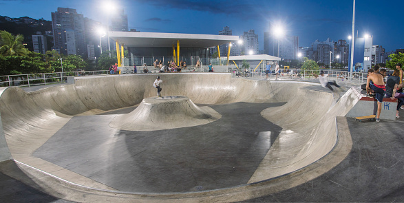 City of Santos, Brazil. 03.31.24. Chorão Skate Park at night. Emissary Park. Boy practicing skateboarding in the bowl.