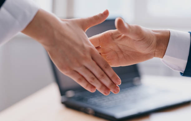 istock Business people shake hands at work In the office employees are mutual understanding 2136163264