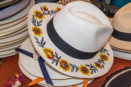 A handmade straw Panama hat, a Paja Toquilla hat or a sombrero with embroidered flowers on. Ecuador. Popular souvenir from South America.