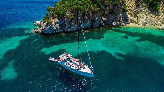 Aerial view of floating boats in Cala Llombards (Santanyi) beach bay in Mallorca Island in Spain during summer sunny day