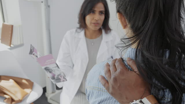 Breast cancer patient asks oncologist questions during appointment