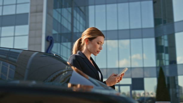 istock Corporate manager scrolling smartphone outside modern office building close up. 2136178418