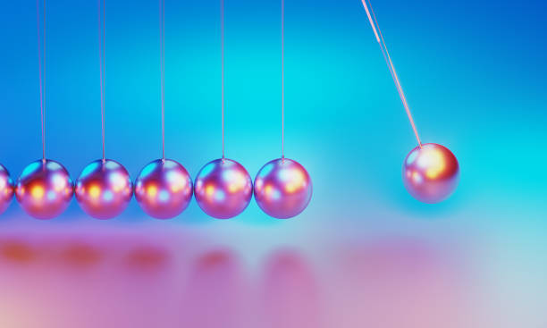 istock Pendulum Illuminated By Pink And Blue Lights On Purple Background 2136179450