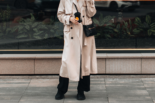 Woman walking around the city with a cup of coffee