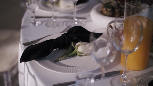 Empty wine glasses on banquet table decorated with flowers