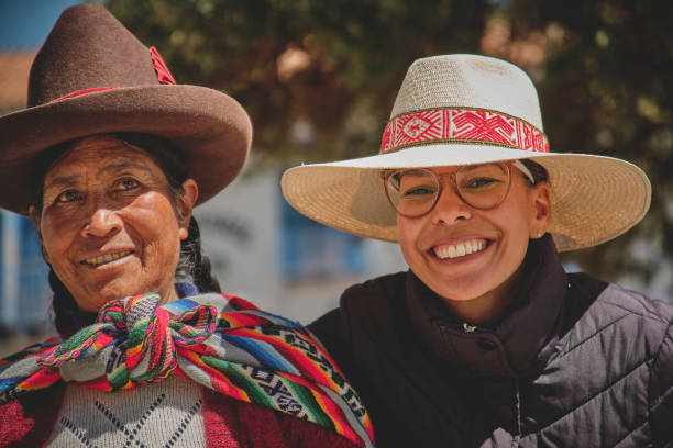 Peruvian woman wearing national clothing posing with llama near Cuzco
