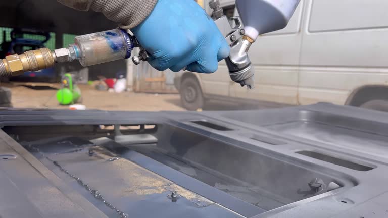 spray painting a car body element