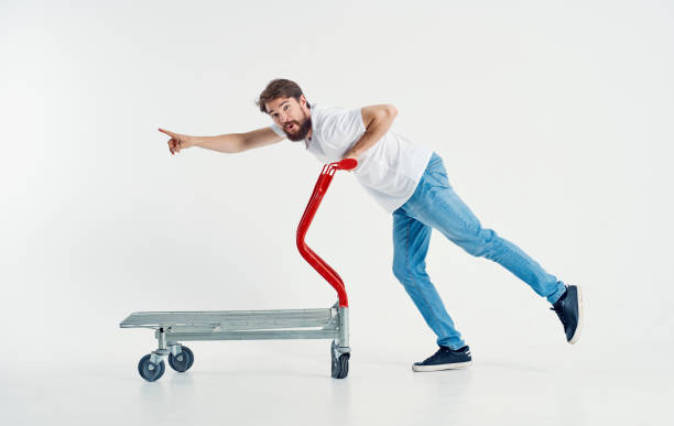 istock cargo trolley man in jeans and sneakers light background work transportation 2136305243