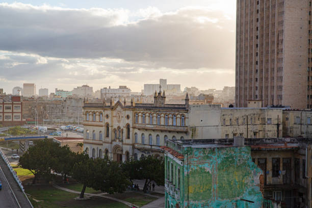 An rriel view  of faded and colonial buildings  in central Havana at the start of sunset.