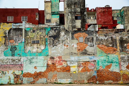 The faded and crumbling side of an apartment building in Havana