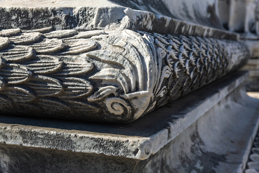 Carved marble wall socle detail, Apollo's Temple at Didima, acanthus leaf pattern, worn textures, shadowed contours. Didim. Aydin, Turkey (Turkiye)