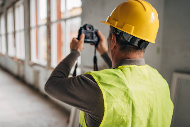 istock Photographer with a camera at the construction site 2136387331
