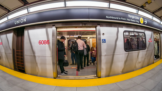 Toronto, Canada - April 1, 2024: Wide angle view of a subway train in the platform of Union Station.