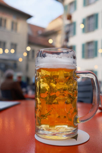 istock Glass of cold beer on table in cafe outside. 2136441354