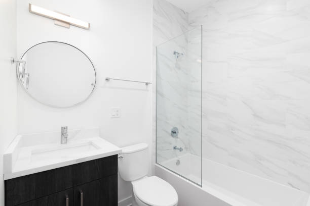 istock A modern bathroom with a wood cabinet and marble shower. 2136459539