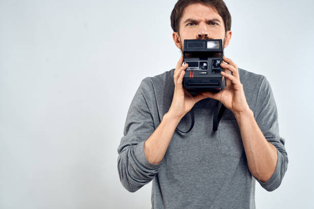 istock Male photographer professional camera work Studio Technology modern art light background 2136462654