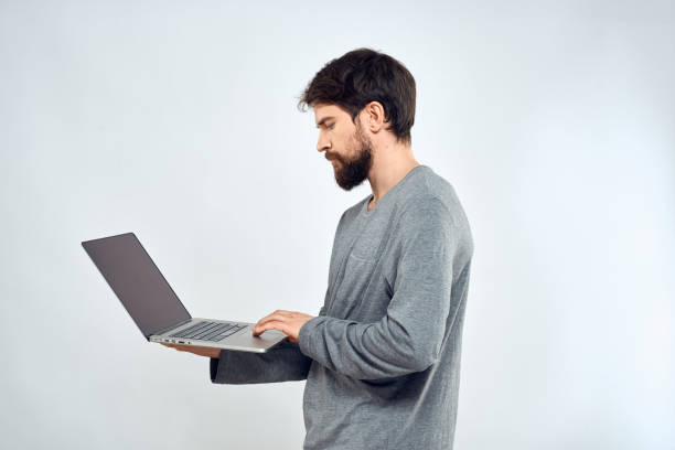 istock A man in a gray sweater with a laptop hands lifestyle technology communication internet work 2136463168