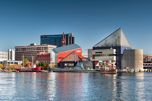 Baltimore, Maryland USA - October 29, 2022: National Aquarium building downtown cityscape and marina on the Inner Harbor of Baltimore Maryland