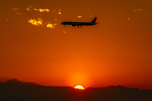 A gorgeous sunset frames multiple Boeing planes landing at Denver International Airport.